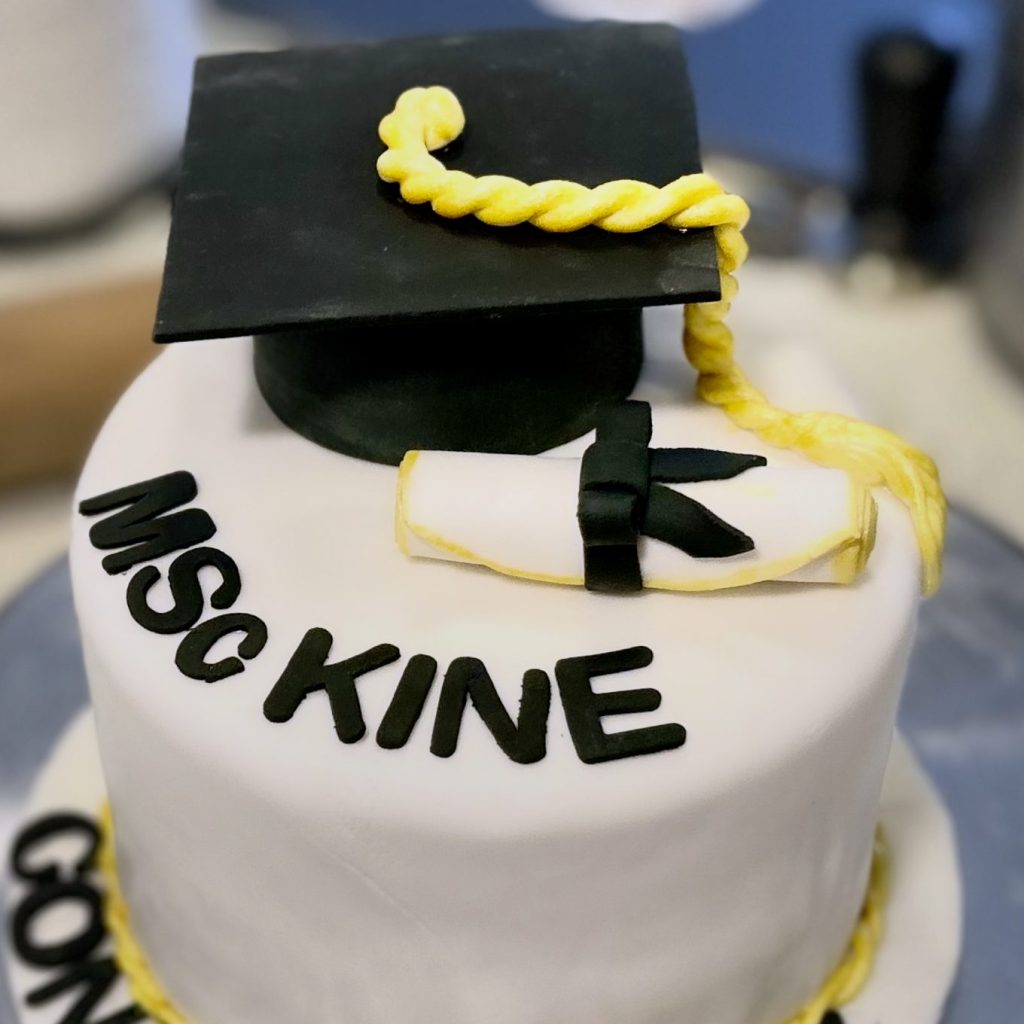 Custom Graduation Dream Cake featuring a handcrafted edible grad cap and diploma, personalized with school colours by Sweet Dreams Cake Boutique.